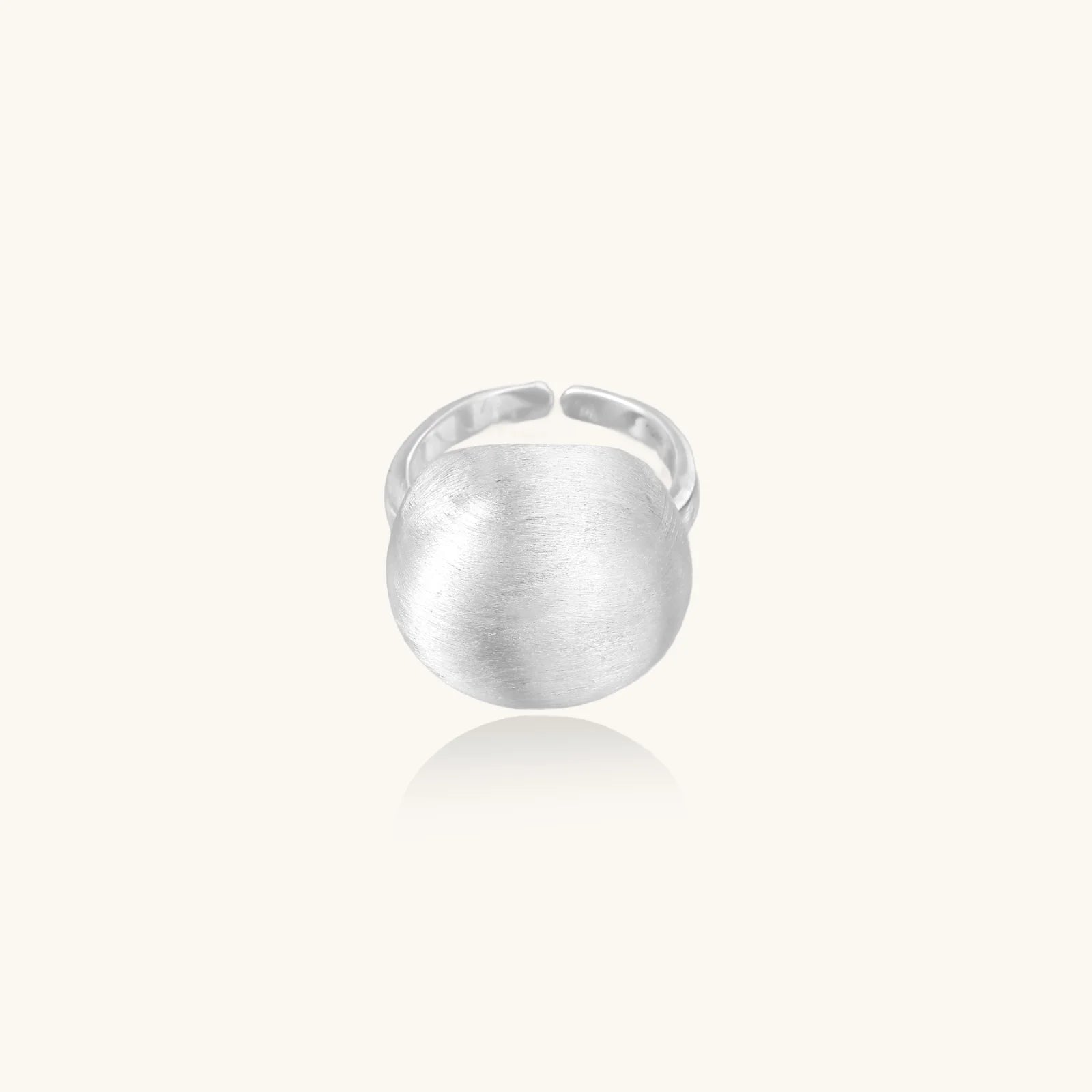 Minimalist brushed sterling silver dome ring with adjustable band on white background, front view.