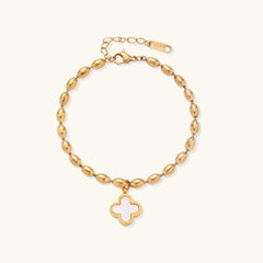 18K gold-plated oval bead chain bracelet with quatrefoil clover charm featuring mother of pearl inlay on cream background