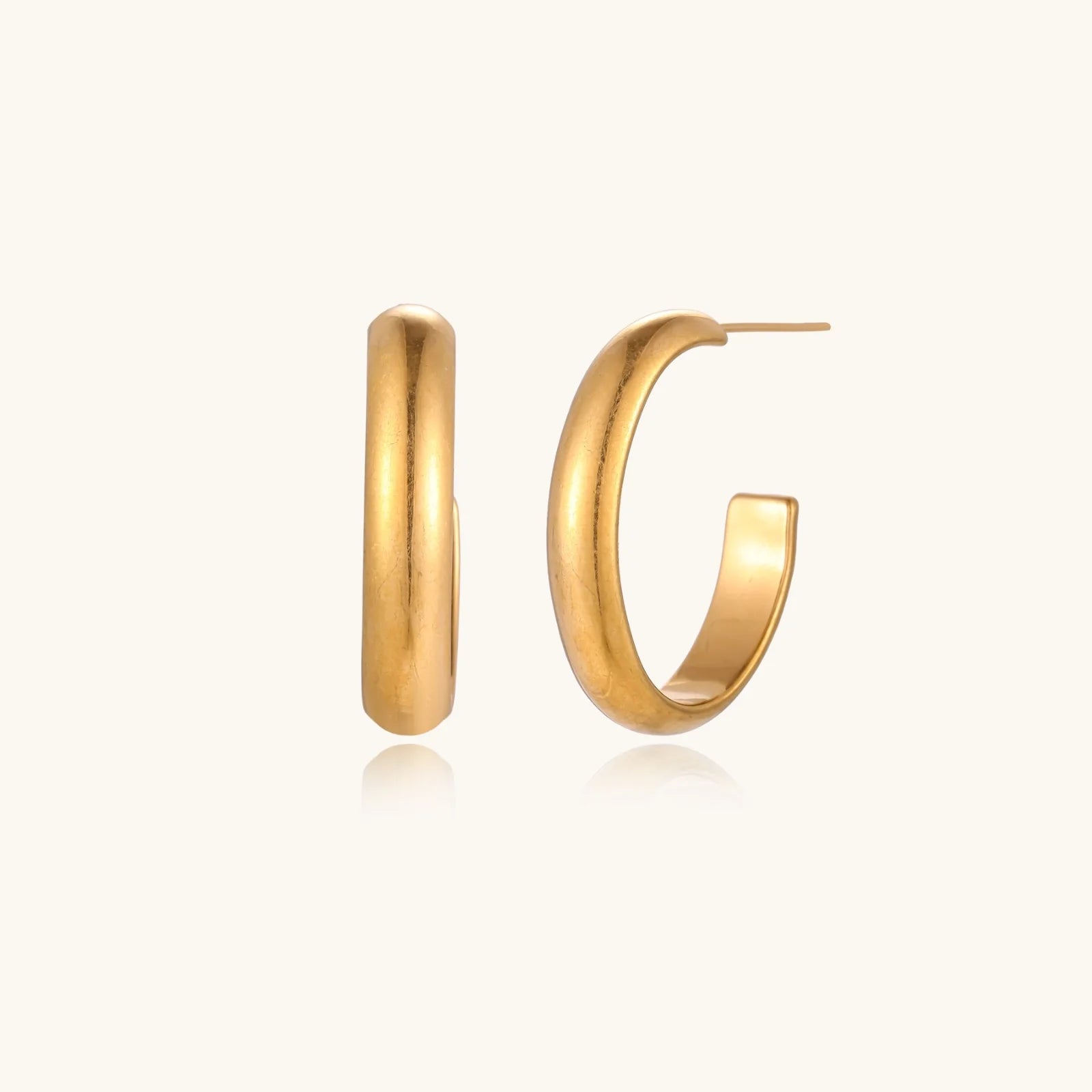 Chunky brushed gold hoop earrings in 14K plated stainless steel on cream background, front and side view.