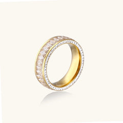 14K gold-plated ring with dual rows of clear baguette and round zirconia stones on cream background.